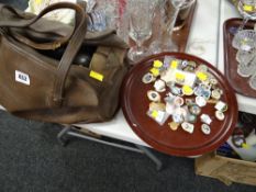 A vintage leather holdall with four Crown Green bowls together with a collection of Crown Green