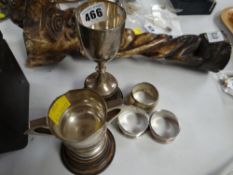 Two hallmarked English silver trophies on plinths and three silver napkins rings