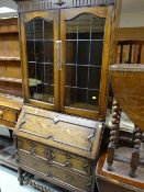 A good vintage barley-twist bureau-bookcase in the Jacobean revival-style with panels and glazed