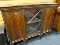 A breakfront bookcase with centre glazed door