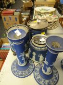 A pair of blue Wedgwood Jasperware candlestick holders and three similar biscuit barrels with EPNS