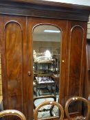 A Victorian mahogany mirrored door wardrobe with base drawer
