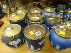 A collection of nine blue Wedgwood Jasperware biscuit barrels each with EPNS lids