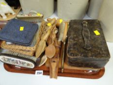 Several carved Welsh wooden love spoons, hairbrushes etc