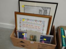 A box of framed prints and cross stitch embroidery