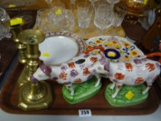 Two Welsh pottery-style cow creamers, pair of brass candlesticks etc