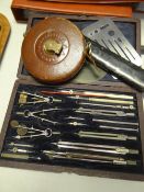 Good cased drawing set and slide rule together with a vintage tape measure