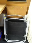 Two grey metal tubular folding garden chairs together with a wallpaper table