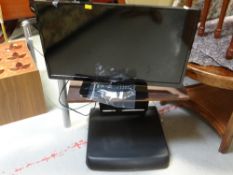 A Logik flatscreen TV and stand