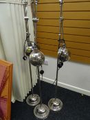 A trio of adjustable headed chrome standard lamps