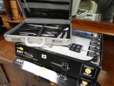 A cased stainless steel carving set together with two boxed TV wall shelves