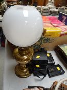 A brass based oil lamp, vintage cameras