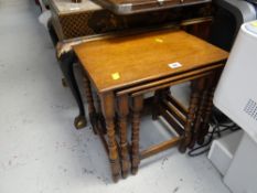 A neat vintage oak nest of three tables with turned legs