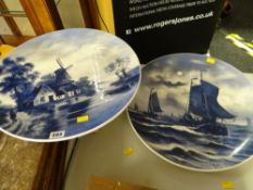 A pair of blue & white circular Delft painted plaques, no. 57 and no. 9 (both signed)