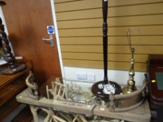 A brass effect table lamp, a standard lamp and a wooden fender