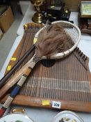 A vintage African bead handled fly swatter, riding crop, tennis racket and zither-style instrument