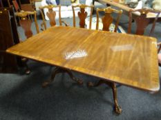 A reproduction dark wood and inlaid twin pedestal Regency-style extending dining table together with