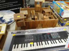 A homemade child's wooden toy fort together with a boxed Yamaha electronic keyboard