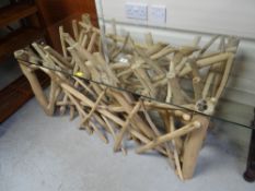 An unusual modern driftwood-style coffee table with glass top