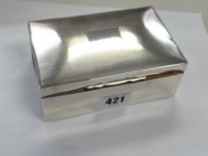 A hallmarked silver engine turned decorated cigarette box