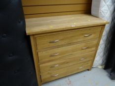 A modern lightwood four-drawer chest of drawers