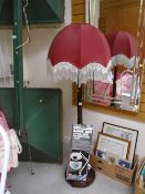 A dark mahogany turned mahogany standard lamp with beaded shade together with a boxed swing arm