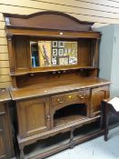 Early twentieth century oak mirror backed dresser on raised feet, single drawer flanked by two