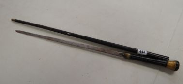 A black metal & gold decorated sword stick