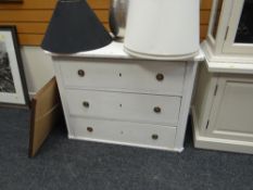 A painted white pine three-drawer chest of drawers