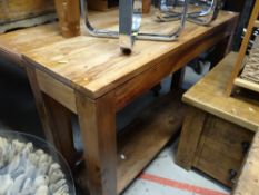A rustic hardwood narrow console / sofa table with bottom shelf