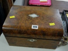 A vintage walnut and mother-of-pearl inlaid travel box and contents