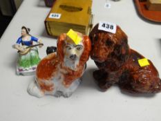 Treacle glazed seated pottery spaniel dog, a traditional Staffordshire spaniel, a figurine with