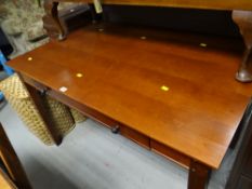 A modern dark wood drop drawer computer / office desk
