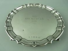 A HALLMARKED SILVER CARD TRAY with wavy border on three hoof feet, Birmingham 1935, 11.5 troy ozs,