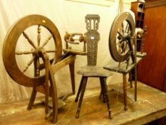 A CARVED SPINNING WHEEL CHAIR and two vintage spinning wheels (as seen)
