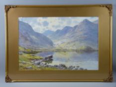 WARREN WILLIAMS ARCA watercolour - Snowdonia lake scene with boat and fisherman, signed, 34 x 51 cms