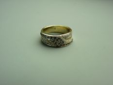 AN EIGHTEEN CARAT YELLOW & WHITE GOLD BLACK & WHITE DIAMOND SET DRESS RING having twenty two tiny