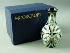 A MOORCROFT 'RAIN DAISY' VASE, 13.75 cms high, decorated on a cobalt ground, designed by Rachel