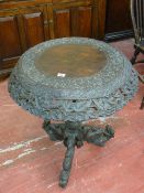 A CARVED BURMESE HARDWOOD TRIPOD TABLE, the 64 cms diameter top with blind and pierced leaf