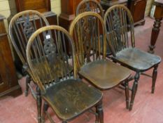 A SET OF FOUR WINDSOR WHEELBACK ELM DINING CHAIRS and one other