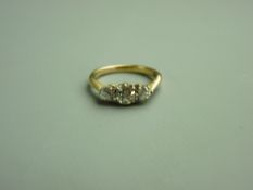 AN EIGHTEEN CARAT GOLD THREE STONE DIAMOND RING, the centre diamond of visual estimate 0.45 carat