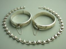 TWO HALLMARKED SILVER LADY'S BANGLES and a modern heavy gauge silver neck chain, the bangles with