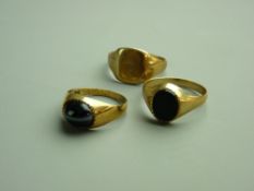 THREE NINE CARAT GOLD SIGNET TYPE RINGS, one with a cabochon agate and the other a dark