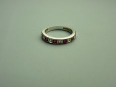 AN EIGHTEEN CARAT WHITE GOLD RUBY & DIAMOND HALF ETERNITY RING, 4.5 grms gross, size 'N'
