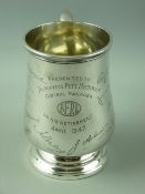 A HALLMARKED SILVER PRESENTATION PINT TANKARD of baluster form with scroll handle, Birmingham