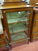AN EDWARDIAN MAHOGANY SINGLE DOOR ASTRAGAL GLAZED DISPLAY CABINET with shaped back rail and lower