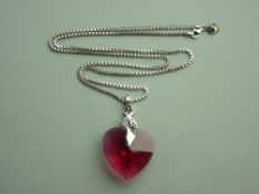 AN ARTIST'S DESIGNED HEART SHAPED RED SWAROVSKI CRYSTAL with silver and black decoration and with