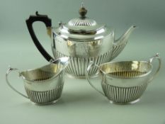A NEAR MATCHED HALLMARKED SILVER THREE PIECE TEA SERVICE of teapot by Elkington & Co, Birmingham