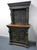 A CARVED OAK FLEMISH STYLE SIDEBOARD. The cornice with fluted decoration over a twin panelled back