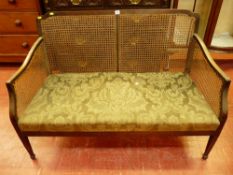 A TWO SEATER BERGERE SETTEE in mahogany with classical style upholstery, square tapering front